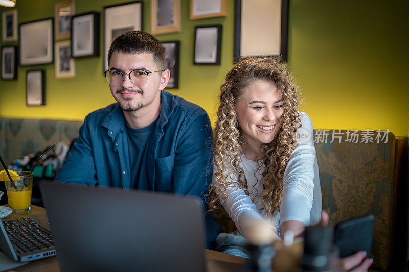 Business people working together at a café using their laptops